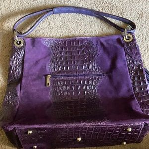 Purple shoulder purse with tassels on the side
